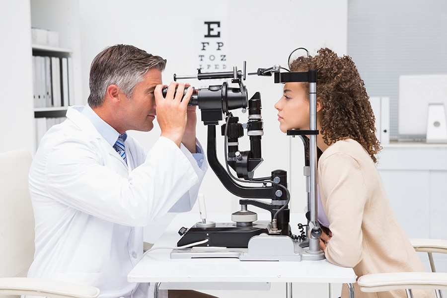 Woman doing eye test with optometrist in medical office